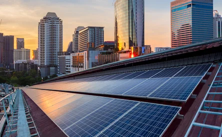 Solar Panel Photovoltaic installation on a Roof of factory, sunny blue sky background, alternative electricity source - Sustainable Resources Concept.