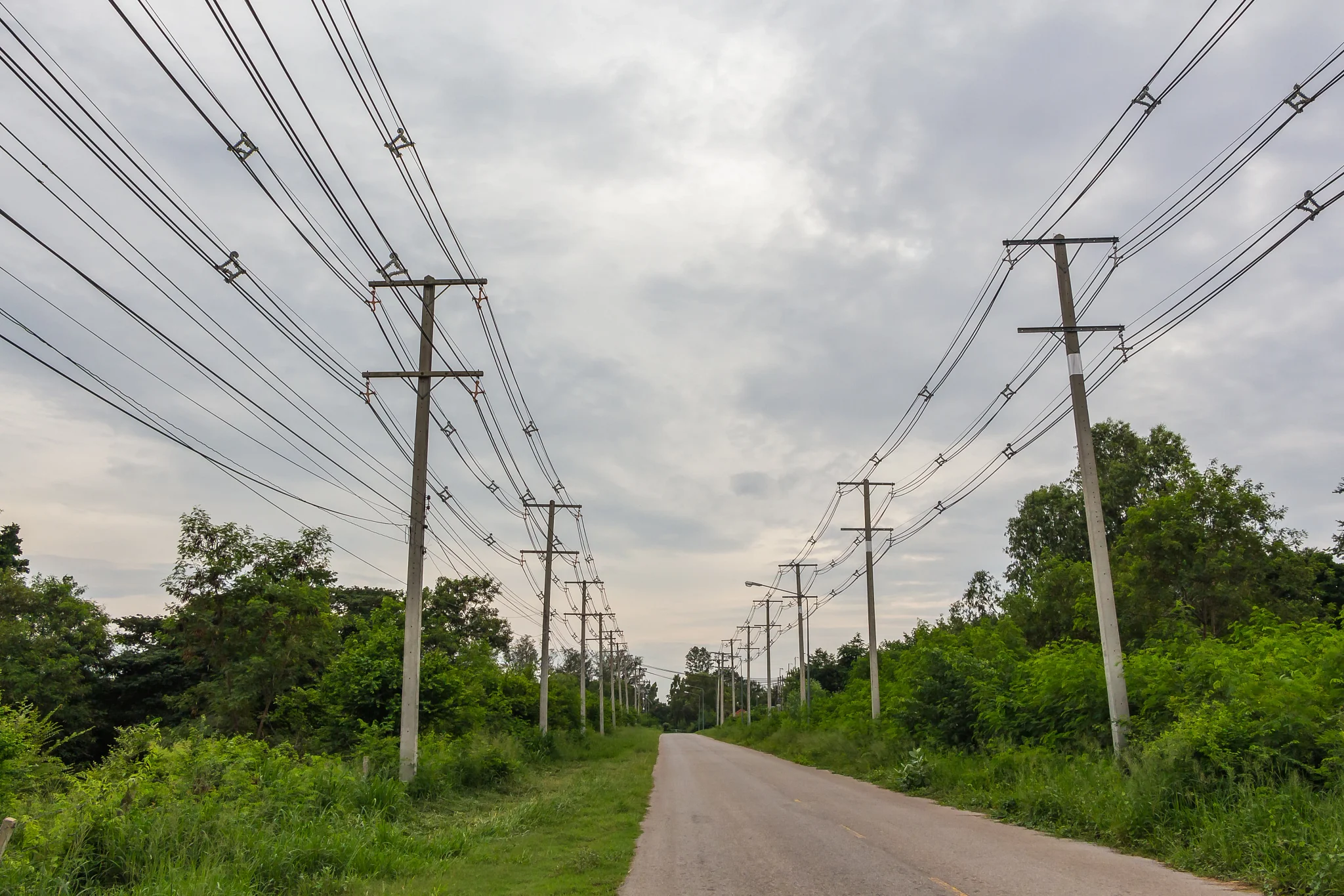 row of wire electric pole inside road.